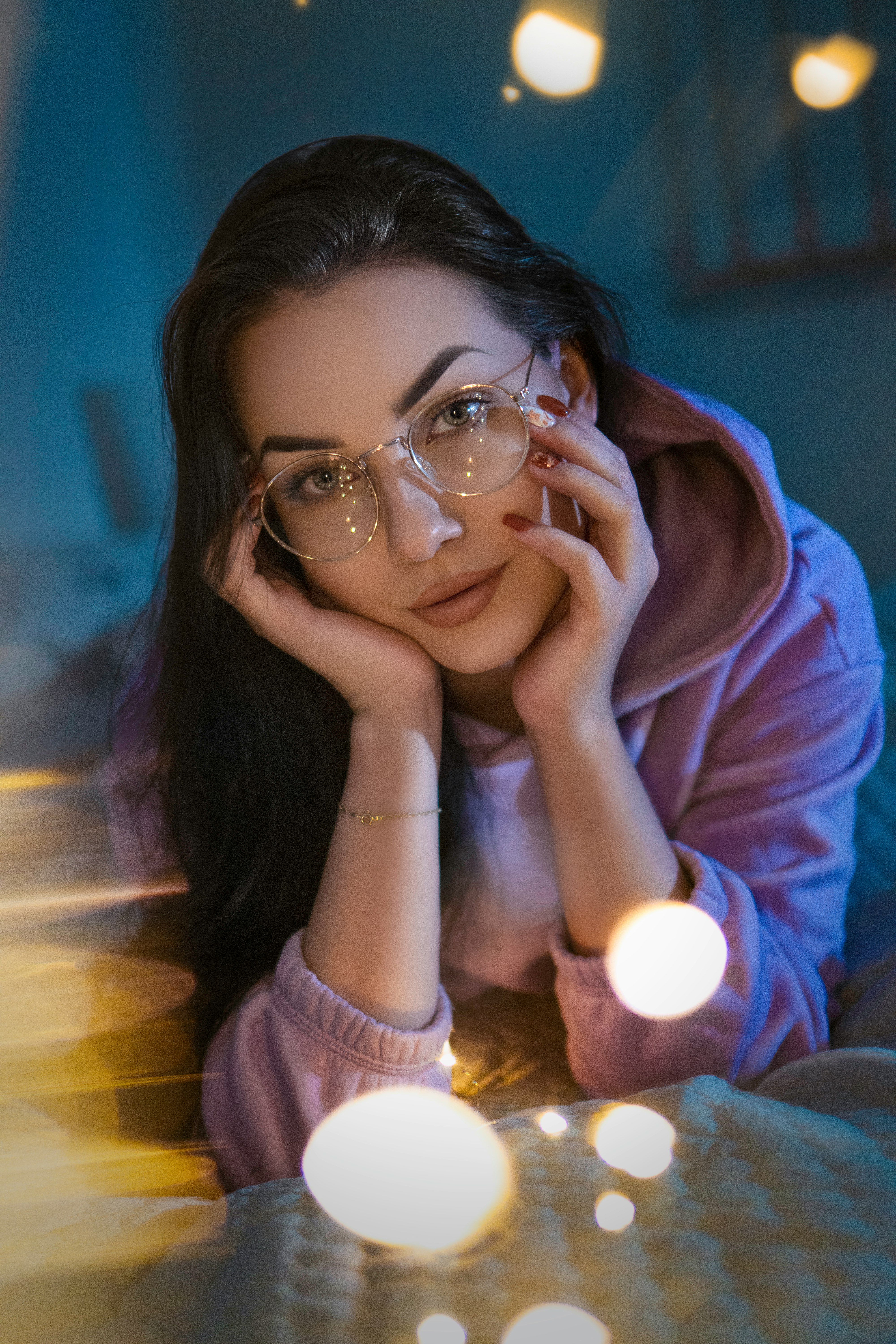 woman in pink hoodie wearing eyeglasses